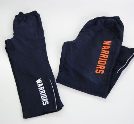 pants with warriors text printed on it