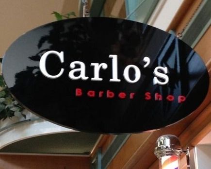 Carlo's barber shop sign install over a door entrance