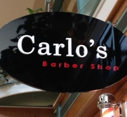 Carlo's barber shop sign install over a door entrance