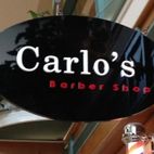 Carlo's barber shop sign install over a door entrance