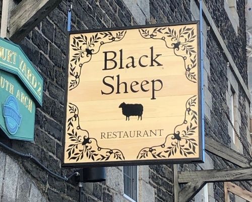black sheep restaurant sign installed