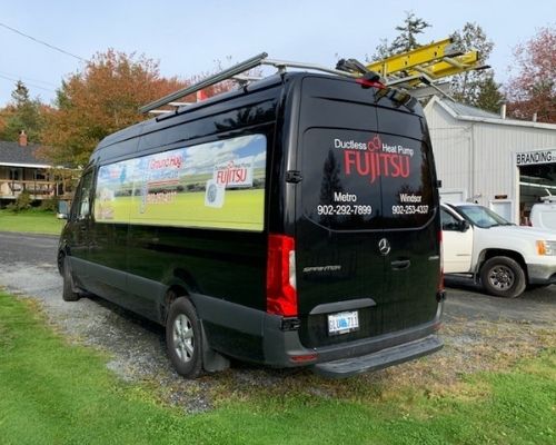 Black van with stickers of fujitsu company