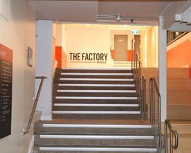 Signage on a wall to a company called the factory